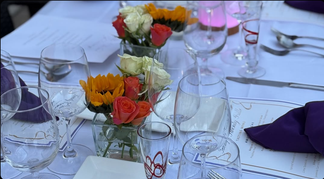 Twenty Twenty Grille event table design with flowers, linens, menus, and glassware